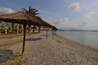 Straw Parasols by the Beach in Nea Kios, Greece