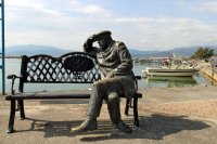 Bronze Fisherman Figure on a Bench in Nea Kios Harbour